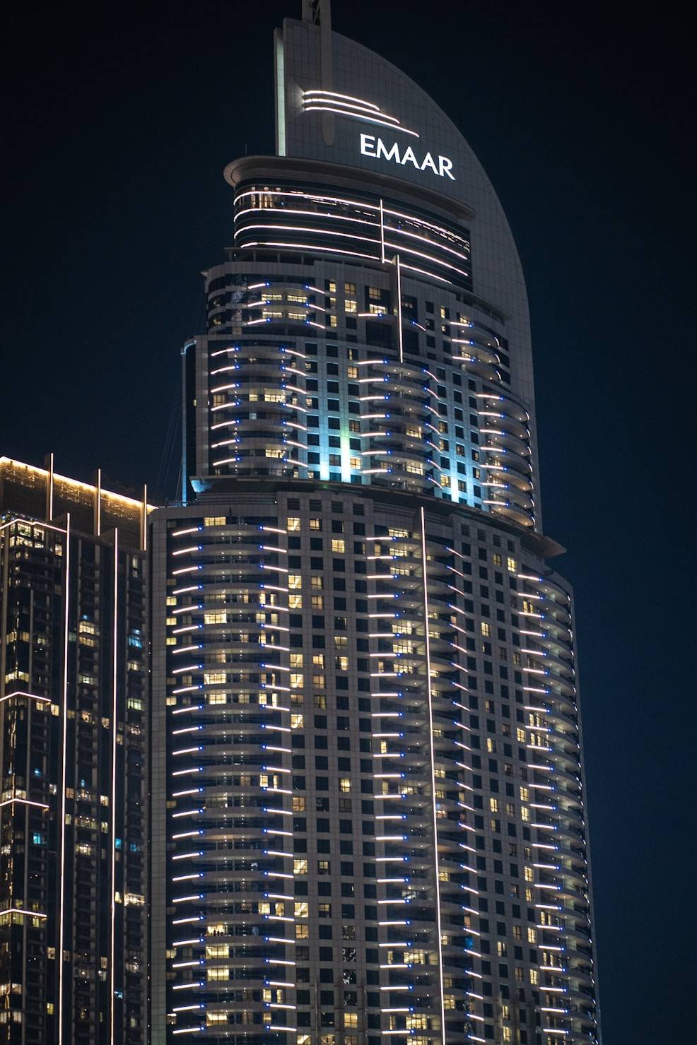 Night view of Emaar tower in Downtown Dubai, showcasing luxury residences and premium real estate.